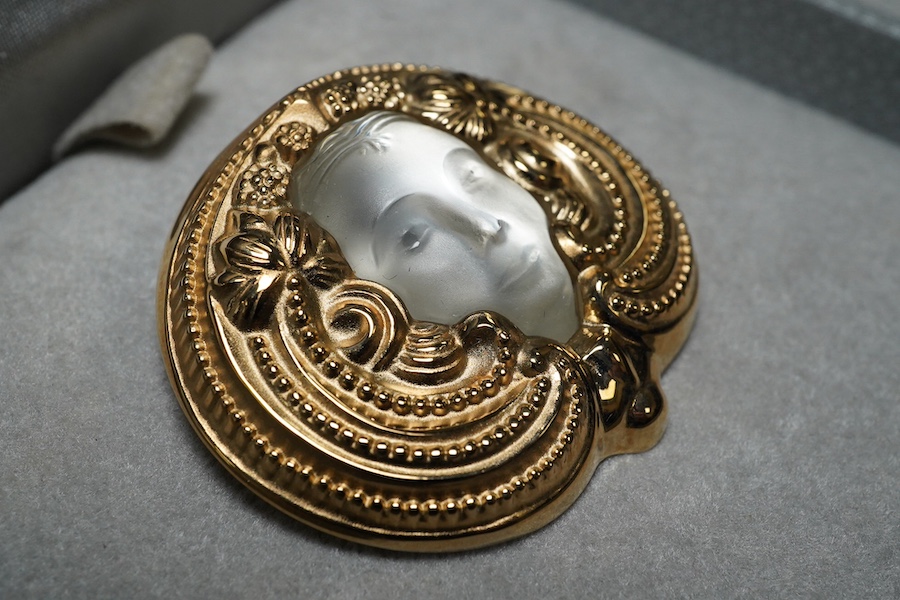 A Lalique mask brooch, cased